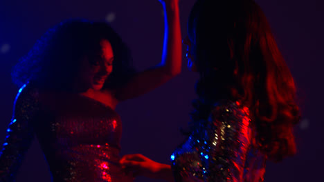 Close-Up-Of-Two-Women-In-Nightclub-Bar-Or-Disco-Dancing-With-Reflected-Sparkling-Lights